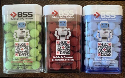 Three packs of free BSS sugar-free mints in wintergreen, cinnamon, and peppermint featuring B-Safe the BSS robot, available at IAEM 2026 Booth 447